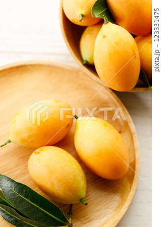 Plum Mango or Marian Plum fruit in wooden tray. 123331475