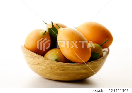 Plum Mango or Marian Plum fruit in wooden tray. 123331508