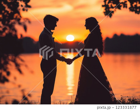 Silhouette of a young couple looking at each other and holding hands with a sunset in the background. Silhouette of a young couple looking at each other and holding hands with a sunset in the background. 123331877