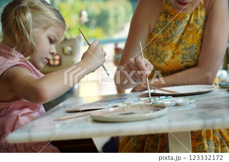 A young mother and her daughter enjoy a creative art session at home A young mother and her daughter enjoy a creative art session at home 123332172