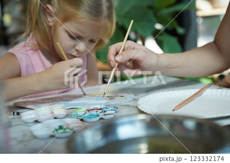 A young mother and her daughter enjoy a creative art session at home  123332174
