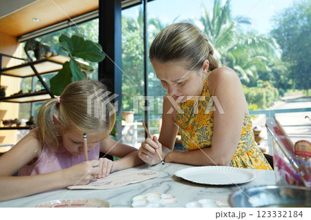 A young mother and her daughter enjoy a creative art session at home  123332184