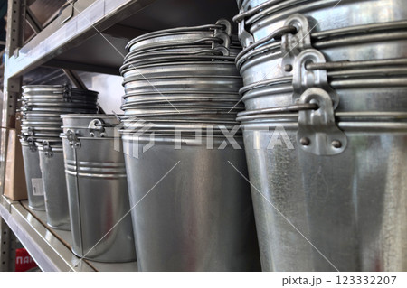 Stacked metal buckets create a unique display in a rustic shop setting 123332207