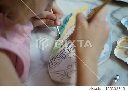 A young mother and her daughter enjoy a creative art session at home A young mother and her daughter enjoy a creative art session at home 123332246