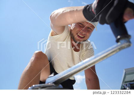 A man in a white hat is working on a voyage boat 123332284
