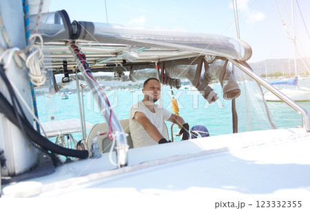 Young male captain in black gloves steering voyage boat Young male captain in black gloves steering voyage boat 123332355