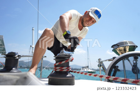 A man in a white hat is working on a voyage boat 123332423