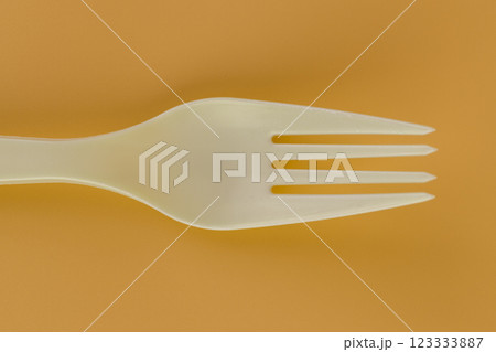 close up soft yellow background pair of plastic white forks disposable tableware eco technology reusable care for the planet picnic set close up soft yellow background pair of plastic white forks disposable tableware eco technology reusable care for the planet picnic set 123333887