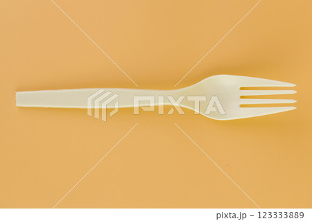 soft yellow background pair of plastic white forks disposable tableware eco technology reusable care for the planet picnic set 123333889