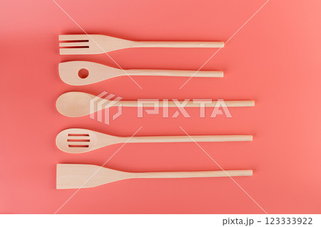 top shot close-up on soft pink background lie new kitchen light wooden utensils of different shapes spatulas for tephlon coating natural wood handmade different types of use top shot close-up on soft pink background lie new kitchen light wooden utensils of different shapes spatulas for tephlon coating natural wood handmade different types of use 123333922