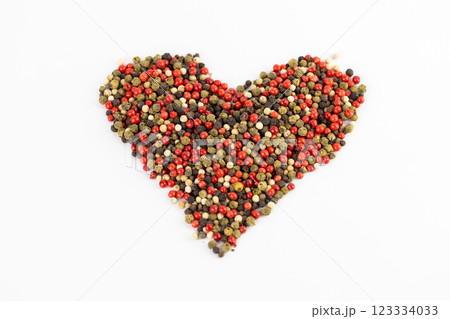white background a pile of mixed large aromatic peppers black red and white the main seasoning for food peppercorns indian and european spices pepper laid out in the shape of a heart white background a pile of mixed large aromatic peppers black red and white the main seasoning for food peppercorns indian and european spices pepper laid out in the shape of a heart 123334033