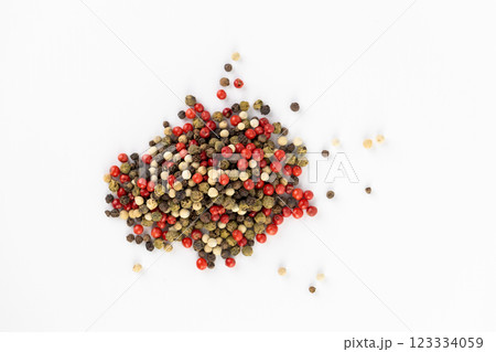 on white background a pile of mixed large aromatic peppers black red and white the main seasoning for food peppercorns indian and european spices the best variety 123334059