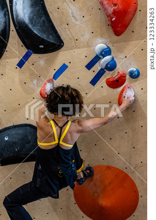 fit woman exercising on climbing wall in gym 123334263
