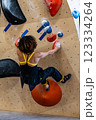 fit woman exercising on climbing wall in gym 123334264