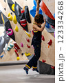 fit woman exercising on climbing wall in gym 123334268