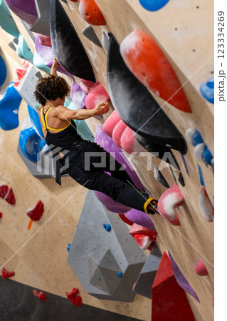 fit woman exercising on climbing wall in gym 123334269