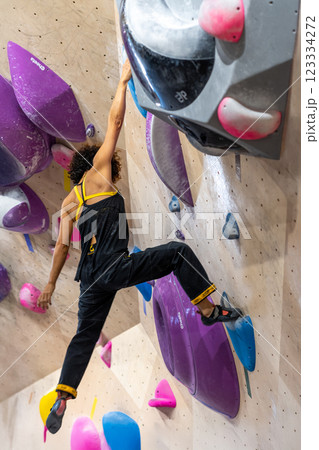 fit woman exercising on climbing wall in gym 123334272