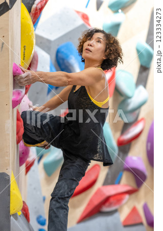 fit woman exercising on climbing wall in gym 123334273