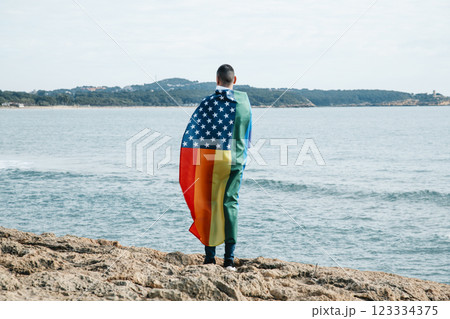 LGBTIQ person wrapped in a rainbow US flag 123334375