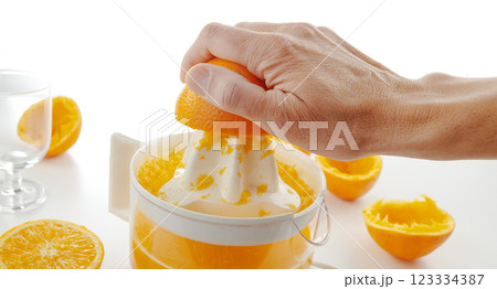 man makes a freshly squeezed orange juice man makes a freshly squeezed orange juice 123334387