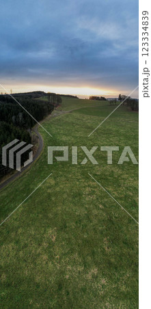 A Serene Landscape at Dusk Featuring Lush, Rolling Green Hills in the Beautiful Countryside 123334839