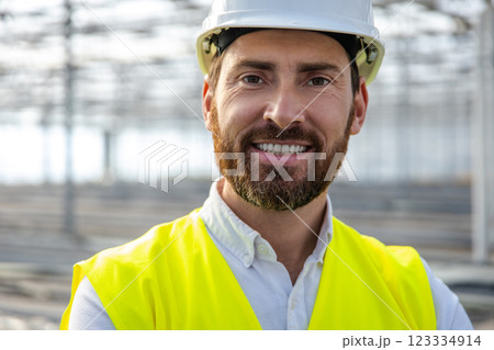 Portrait picture of a young caucasian engineer in a protective helmet 123334914