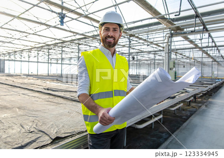 Young male engineer in a hardhat in a greenhouse 123334945