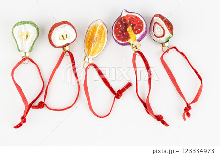top shot Christmas toys in shape of fruits, tangerines and apples, lie on a white background and strawberries pears and strawberries glass Christmas toys modern decor top shot Christmas toys in shape of fruits, tangerines and apples, lie on a white background and strawberries pears and strawberries glass Christmas toys modern decor 123334973