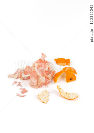 on white background lies the peel of a peeled tangerine and pink pamela natural fertilizer environmentally friendly product vitamin C seedless madarines on white background lies the peel of a peeled tangerine and pink pamela natural fertilizer environmentally friendly product vitamin C seedless madarines 123335043