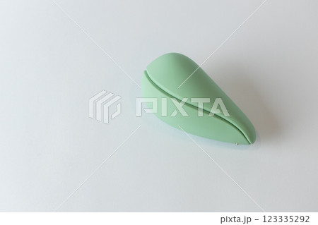close-up on white background lies closed in the shape of an egg light mint vacuum female vibrator various sex toys moisture-resistant toy modern devices 123335292