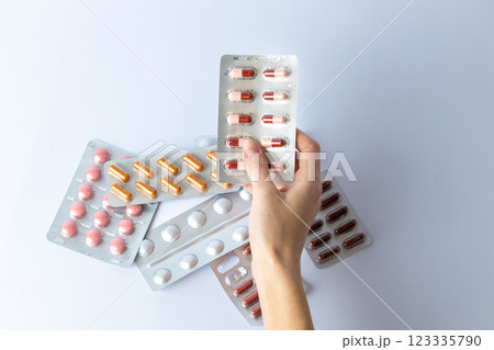 on white background on an outstretched female hand a silver blister with colored capsules suicidal thoughts depression health care pills in the air medical care others on the table on white background on an outstretched female hand a silver blister with colored capsules suicidal thoughts depression health care pills in the air medical care others on the table 123335790