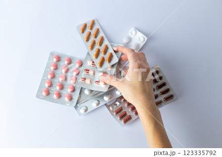 on white background on an outstretched female hand a silver blister with colored capsules suicidal thoughts depression health care pills in the air medical care others on the table 123335792