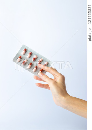 on white background on an outstretched female hand a silver blister with colored capsules suicidal thoughts depression health care pills in the air medical care on white background on an outstretched female hand a silver blister with colored capsules suicidal thoughts depression health care pills in the air medical care 123335822