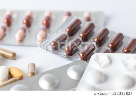 closeup white background on the table there are different silver blisters with colored capsules and tablets suicidal thoughts depression health care medical care vitamins on the table 123335827