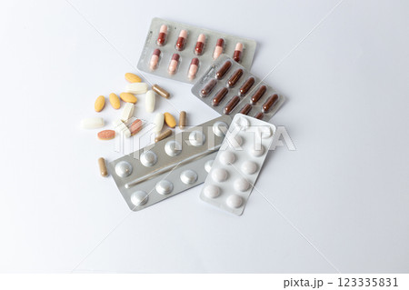 on white background on the table there are different silver blisters with colored capsules and tablets suicidal thoughts depression health care medical care vitamins without packaging on the table on white background on the table there are different silver blisters with colored capsules and tablets suicidal thoughts depression health care medical care vitamins without packaging on the table 123335831