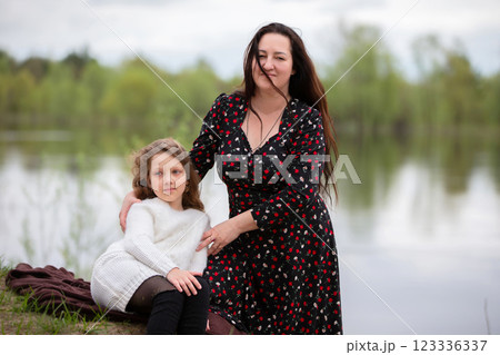 Mom and daughter enjoy a walk in the park on Mother's Day. 123336337