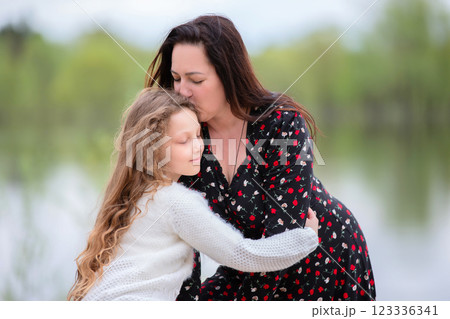 Mom and daughter enjoy a walk in the park on Mother's Day. Mom and daughter enjoy a walk in the park on Mother's Day. 123336341