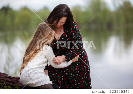 Mom and daughter enjoy a walk in the park on Mother's Day. Mom and daughter enjoy a walk in the park on Mother's Day. 123336343