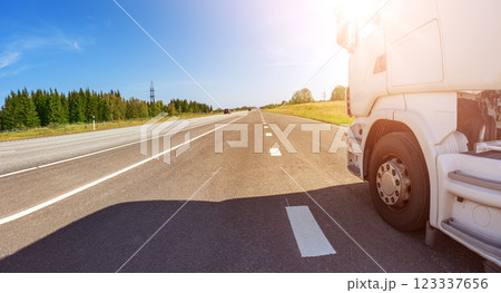 Closeup panoramic view of the white truck driving on the asphalt road. 123337656