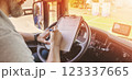 Truck driver sitting in the car and writing documents. 123337665