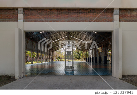 Basketball backboard with the hoop metal ring inside indoor basketball court at city park. 123337943