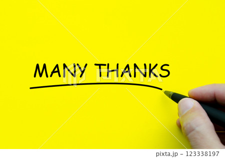 Top view of yellow cover with hand writing Many Thanks text Top view of yellow cover with hand writing Many Thanks text 123338197