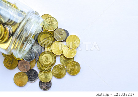 Top view of golden coins in a jar with customizable space for text. Copy space concept Top view of golden coins in a jar with customizable space for text. Copy space concept 123338217