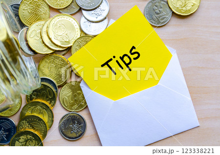 Tips text on yellow paper covered with white envelope. 123338221