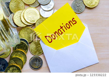 Donate Today text on yellow paper covered with white envelope 123338222