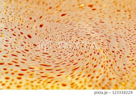 Rain droplets twill effect on an orange golden color background with customizable space for text or ideas Rain droplets twill effect on an orange golden color background with customizable space for text or ideas 123338229