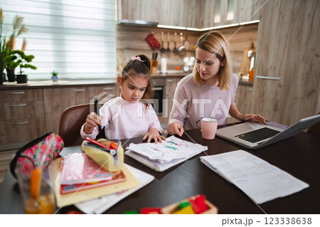 Creative learning moment captured in a cozy kitchen environment 123338638