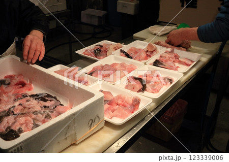 アンコウの切り身をパック詰めする魚屋 123339006