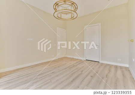 A clean and spacious interior featuring wooden flooring and minimalist design, ideal for various settings and decor styles. Natural light enhances the serene atmosphere. A clean and spacious interior featuring wooden flooring and minimalist design, ideal for various settings and decor styles. Natural light enhances the serene atmosphere. 123339355