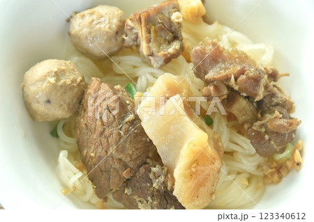 dry boiled thin rice noodles topping slice braised beef meat and tendon with meatball on bowl 123340612